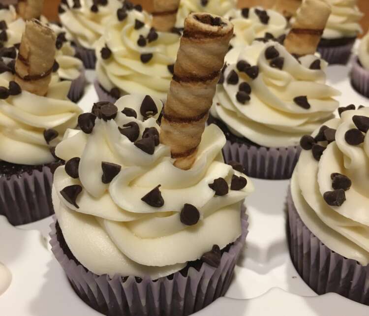 Mocha Frappuccino Cupcakes, topped with cream cheese frosting, mini chocolate chips, and a cookie straw