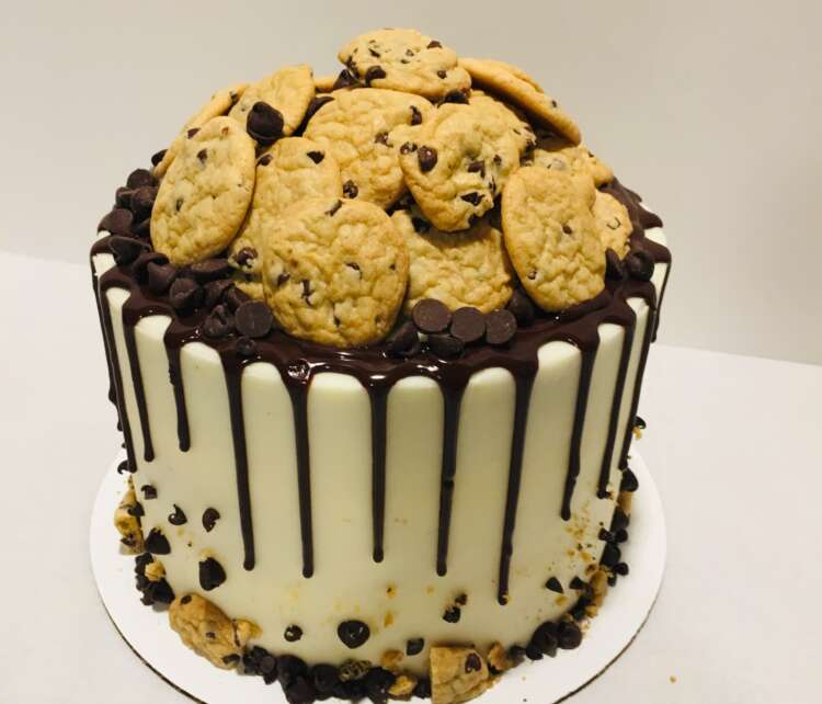 Chocolate Chip Cookie Butter Cake; filled with cookie butter and topped with a chocolate ganache drip and mini cookies