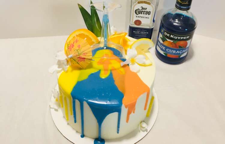 Hawaiian Sunrise Cake; tequila and orange liqueur cake with a blue, orange, and yellow drip