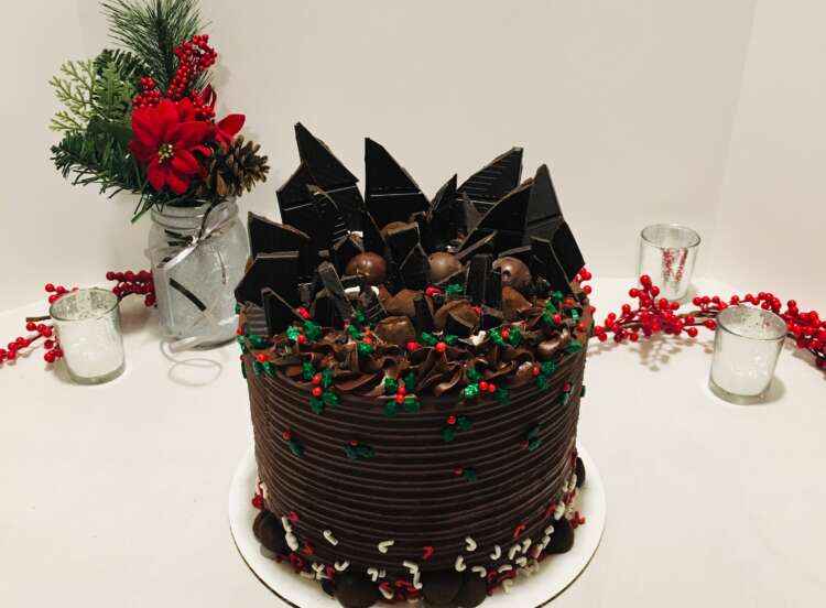 Fudge Truffle Overload Cake, decorated with broken chocolate bars and fudge truffles