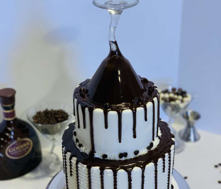 Coffee Cocktail Cake, decorated with a chocolate ganache drip and a martini glass