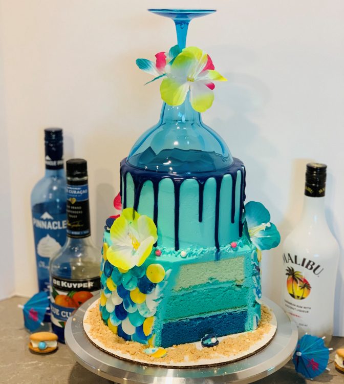 Mermaid Cocktail Cake (slice cut, topped with a cocktail glass and decorated with mermaid scales)