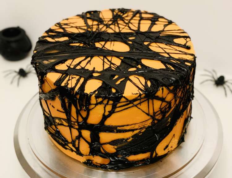 Black Spider web cake - orange cake covered with black marshmallow spiderweb