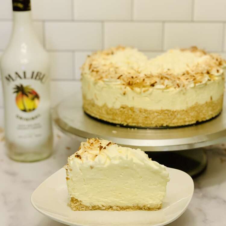 Coconut rum cheesecake thumbnail image. Slice cut from cheesecake to show texture in foreground.