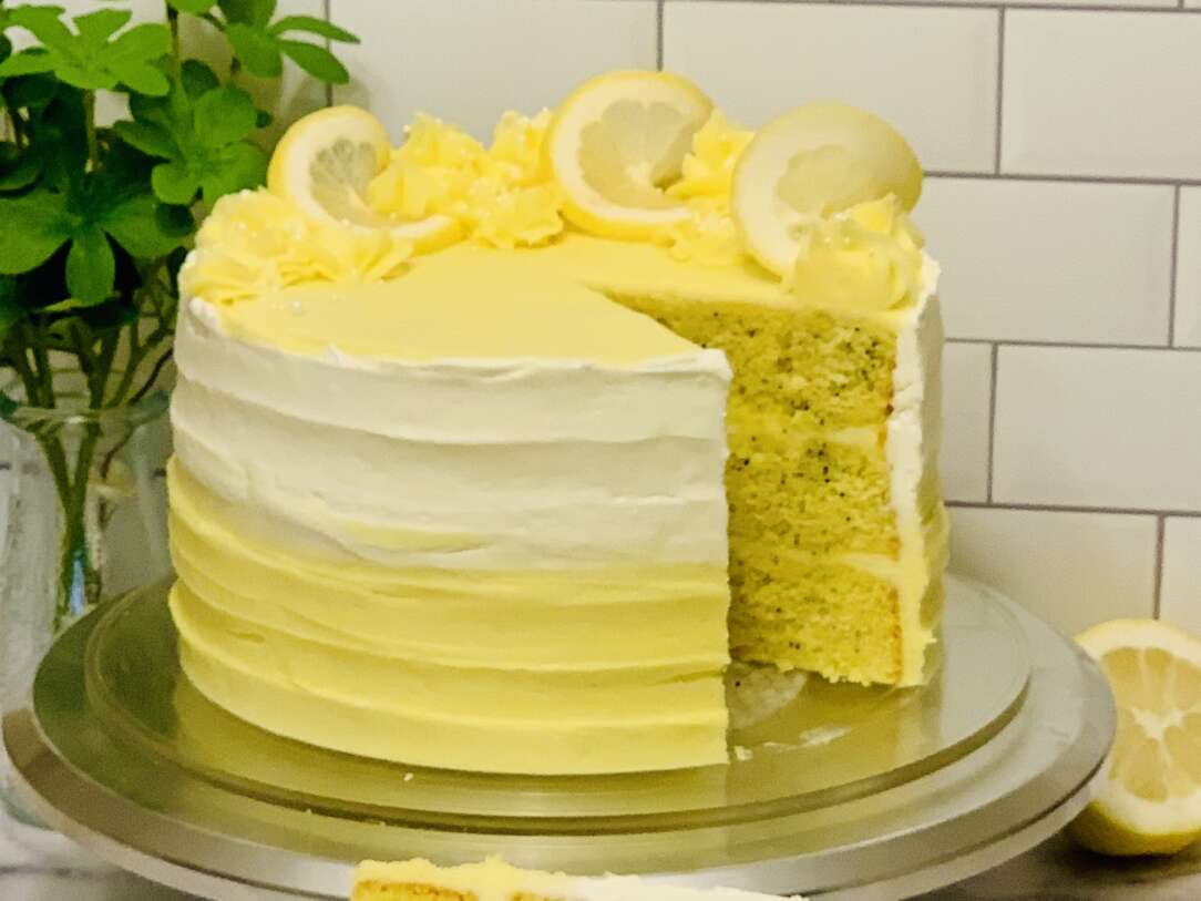 Lemon Poppyseed Sourdough Discard cake - thumbnail image w slice cut from cake to show 3 yellow lemon poppyseed layers inside